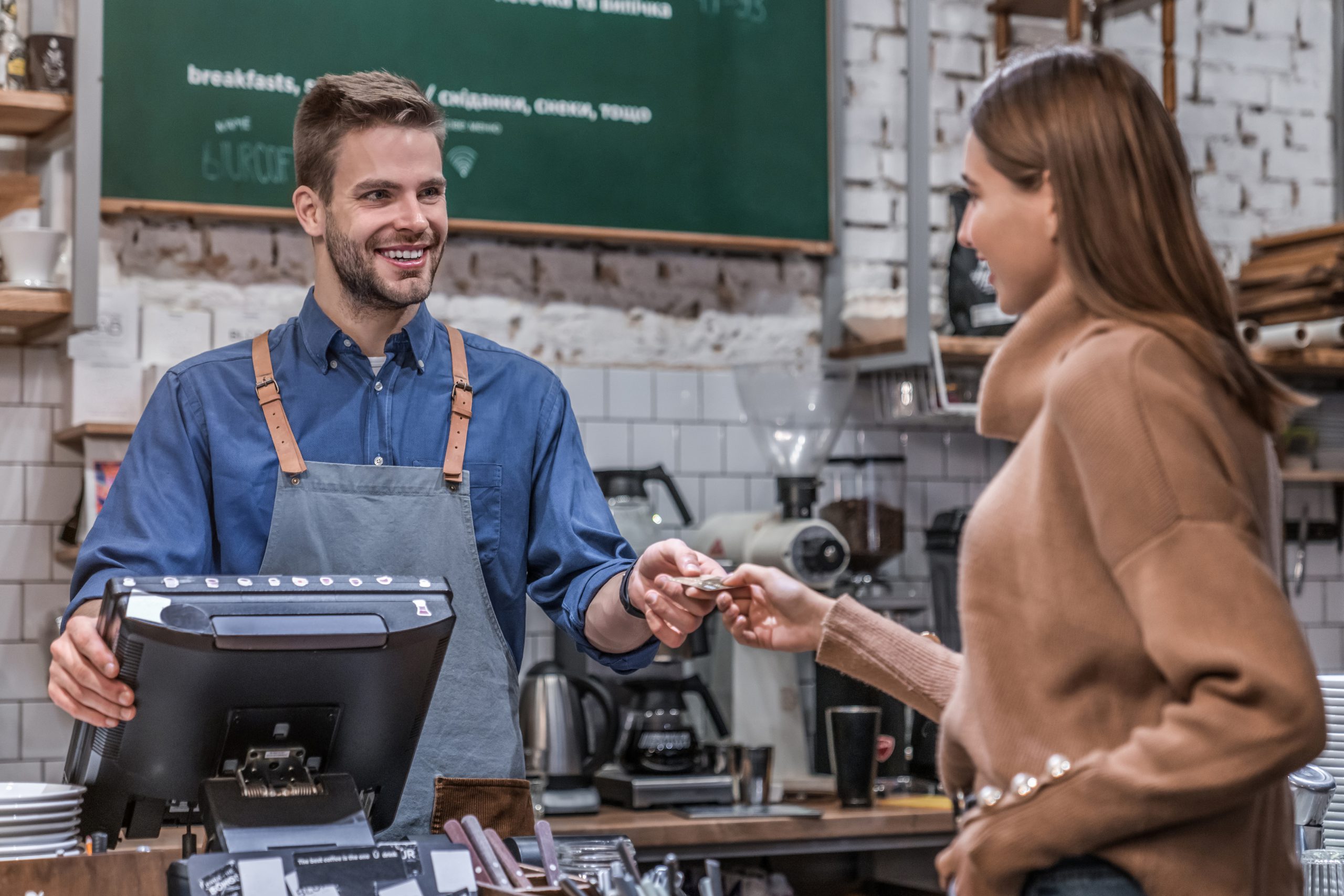 Customer paying by credit card at cafe