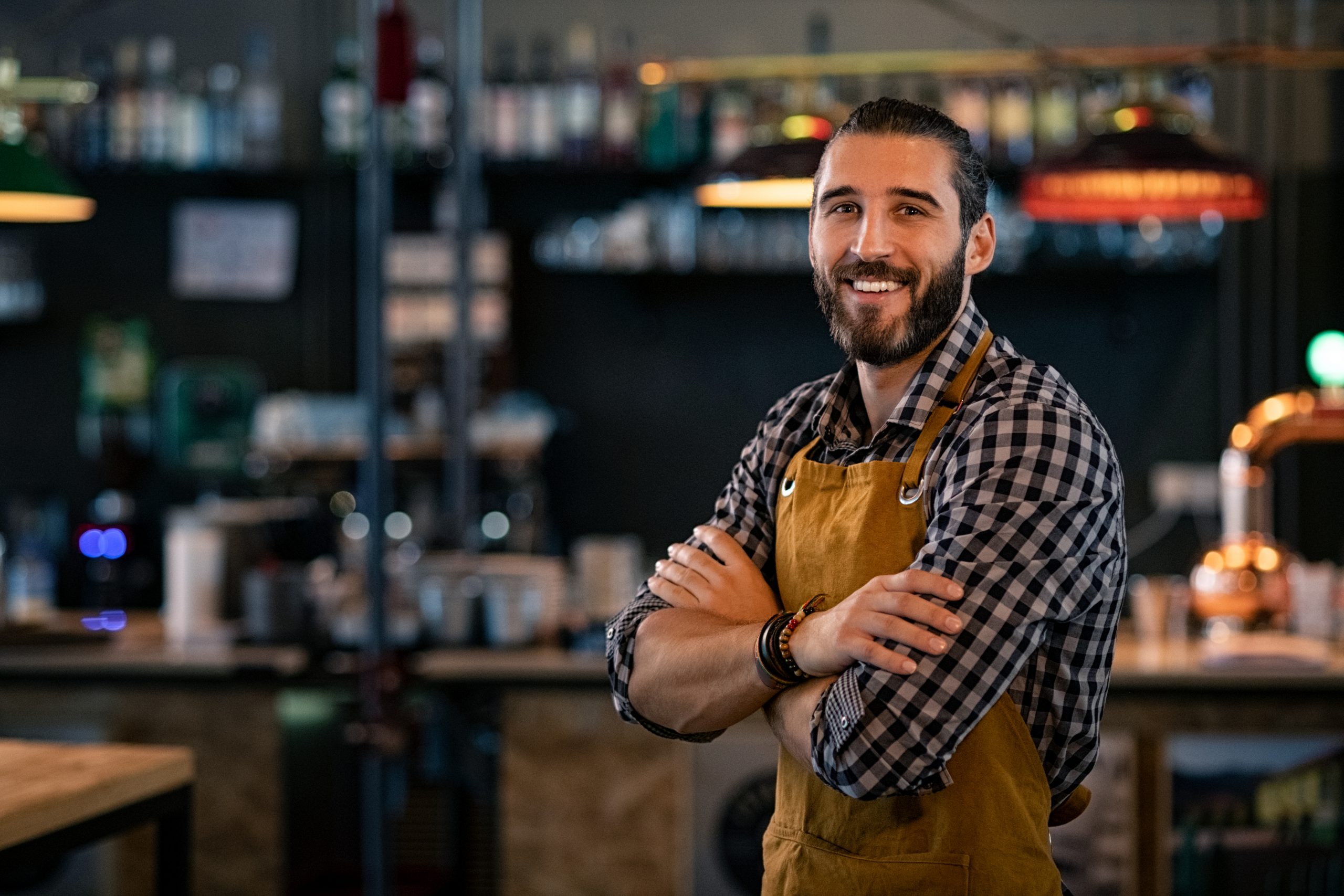 Bartender wearing apron and smiling